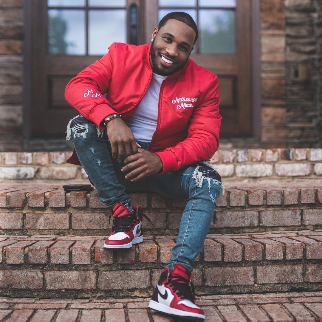 Brandon Medford in a red jacket on a Brooklyn stoop